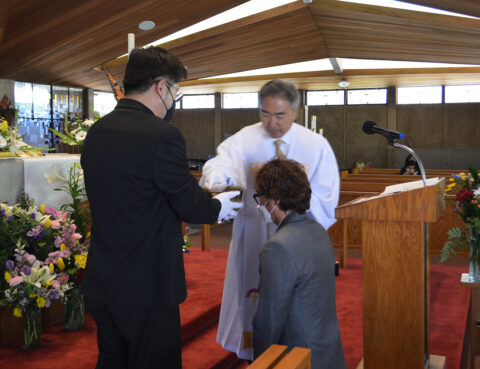 A religious ceremony with a person receiving a blessing or anointment.