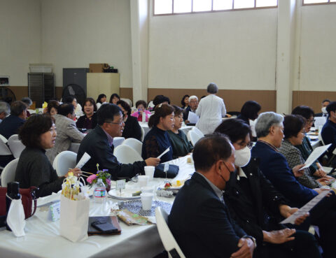 People gathered in a hall for an event or meeting.