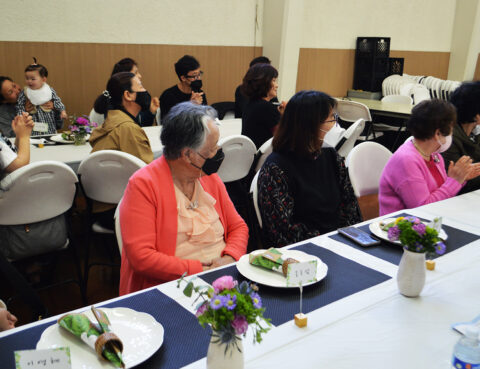 People gathered around a table enjoying a meal together indoors.