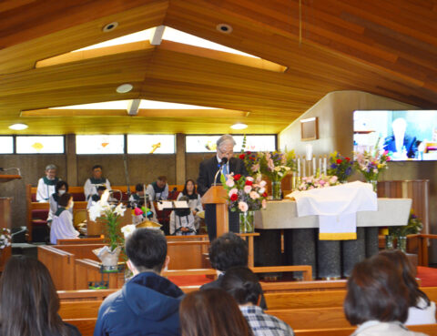 Congregation gathered inside a wooden church during a service.