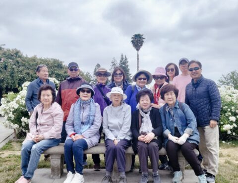 Group photo of people outdoors on a cloudy day.